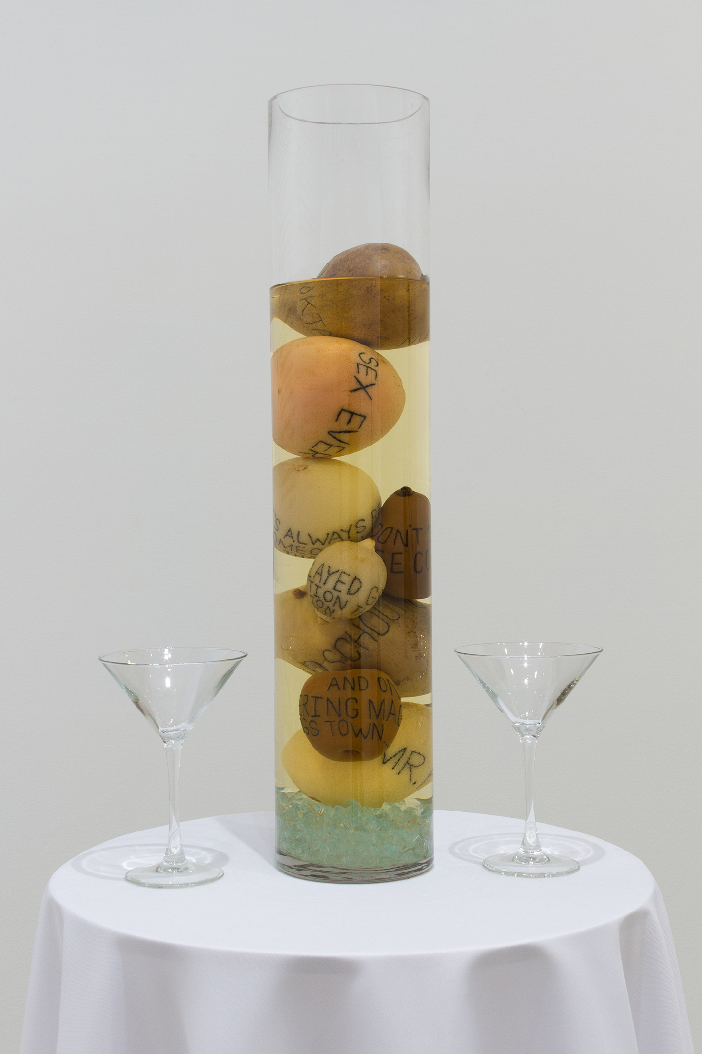 Extreme detail of a column filled with tattood fruit and alcohol